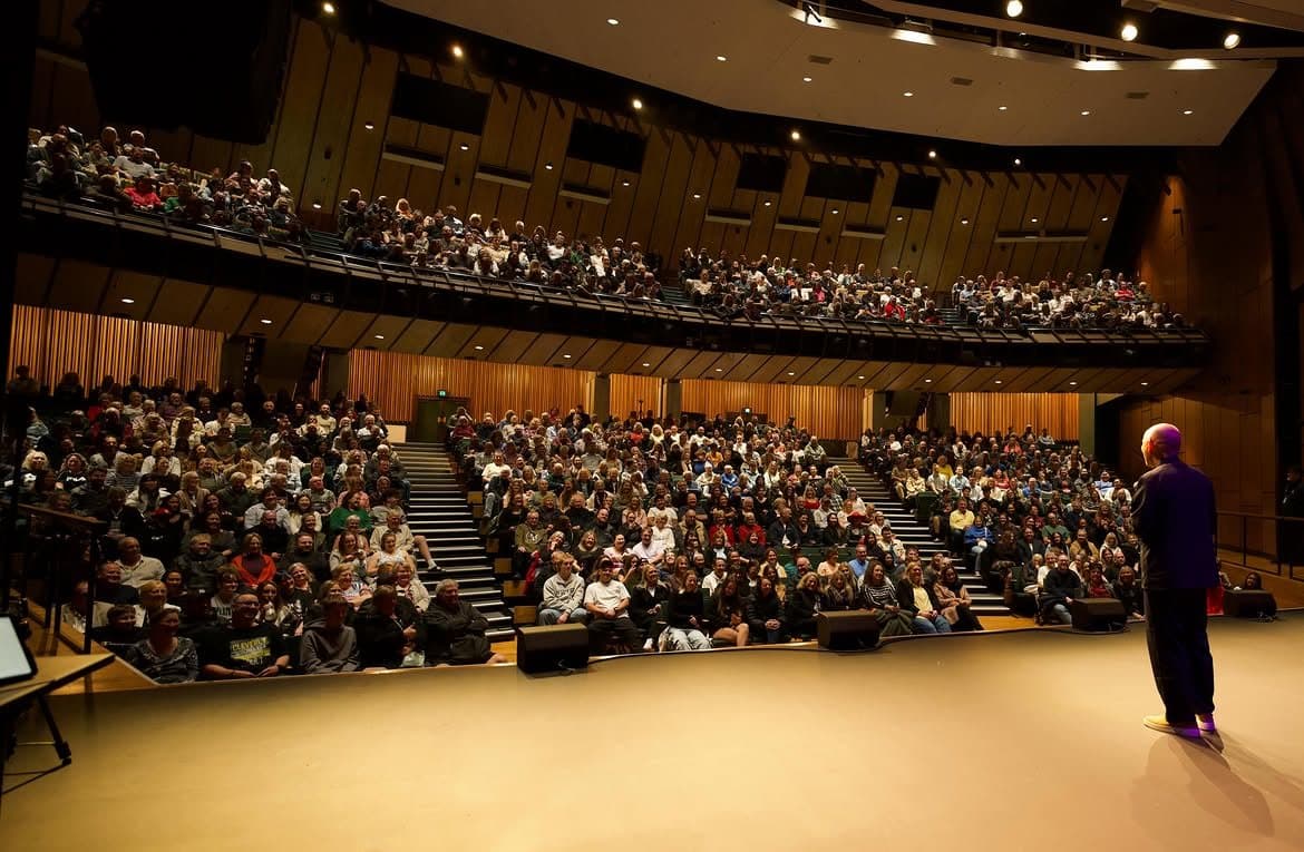 Haiming Jiang on stage before a sold-out theatre audience