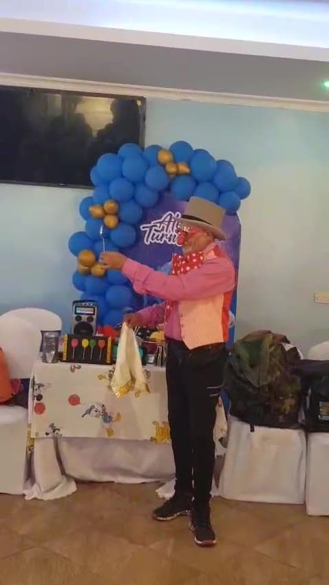 Sadiq performing a silk trick at a birthday table