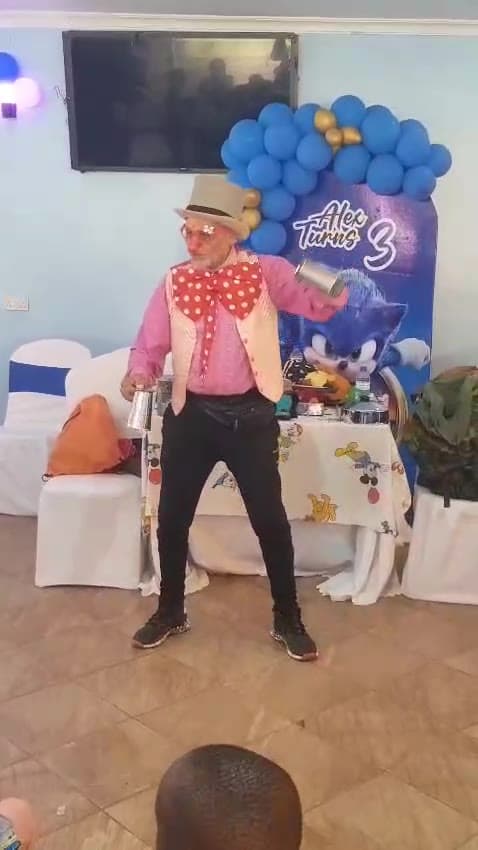 Sadiq mid-performance in top hat and polka-dot bow tie